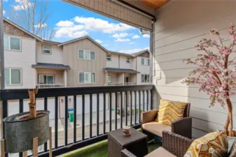 The covered balcony offers extended outdoor living.