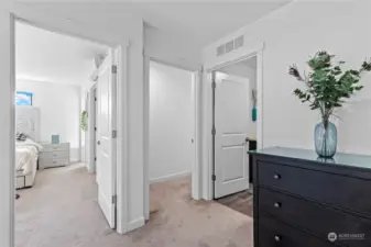 This level boasts two primary suites with private baths and a convenient laundry room.