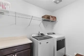 Laundry room with built-ins for added storage.