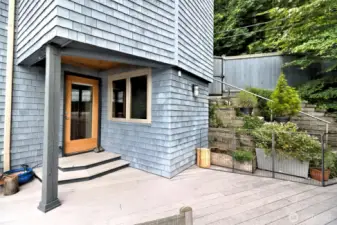 The main entry door with the steps coming down from the parking area on the right.