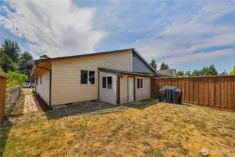 Spacious fenced backyard with enclosed patio