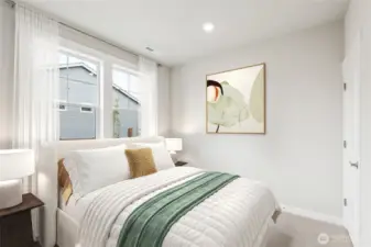 Main level bedroom with bath with walk-in shower next to it. Photo is representational. Actual home is under construction and finishes and colors will vary. See site agent for details.