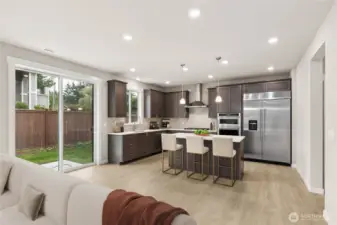 View of the gourmet kitchen with separate eating area. Photo is representational. Actual home is under construction and finishes and colors will vary. See site agent for details.