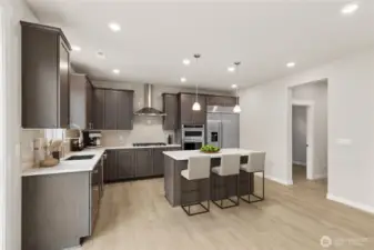 View of the gourmet kitchen with separate eating area. Photo is representational. Actual home is under construction and finishes and colors will vary. See site agent for details.