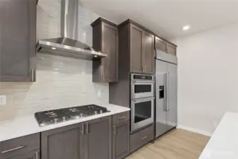 Home is equipped with gas cooktop and standalone vent. Photo is representational. Actual home is under construction and finishes and colors will vary. See site agent for details.