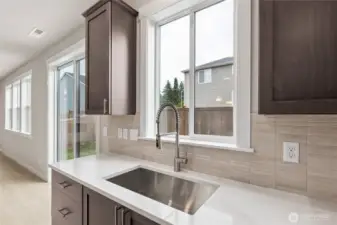 Under mount sink with Moen pull down fauct with sprayer.  Photo is representational. Actual home is under construction and finishes and colors will vary. See site agent for details.