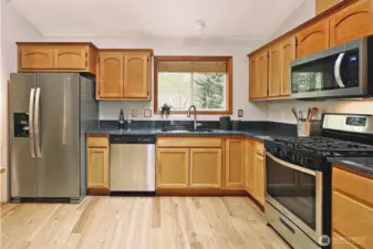 Main floor kitchen with new fridge and microwave