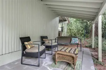 Enjoy the peaceful outdoors no matter what the weather's like on this covered patio.