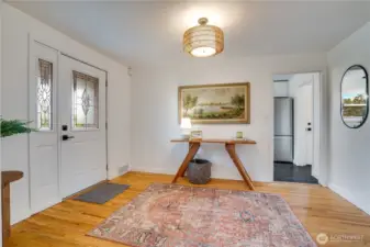 Glowing refinished hardwood floors greet you the moment you step inside. Light pours through the new front door with decorative leaded-glass sidelights, and the open, airy entry sets the tone for this fully renovated North Tacoma rambler.