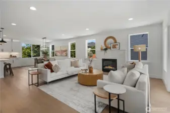 Great Room View Two: Cozy yet open living area anchored by a striking fireplace and surrounded by natural light. Perfectly designed to flow into the dining and kitchen areas for comfortable Eastside living. Staged photos are of the model home of the same floorplan within the Foxmoore community and are for visualization purposes only. Colors, finishes, and layout can and will vary.