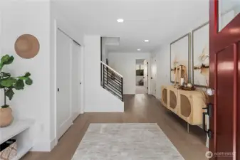 Entry Foyer: The entry foyer welcomes you with wide-plank flooring, recessed lighting, and modern iron stair railings that make an immediate statement. Ample closet space and a clean design create a functional and stylish first impression. Staged photos are of the model home of the same floorplan within the Foxmoore community and are for visualization purposes only. Colors, finishes, and layout can and will vary.