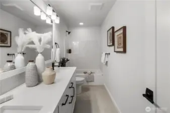 Full Bathroom: Upstairs bathroom with dual-sink vanity, modern fixtures, and a full tub/shower combo. Clean lines and bright finishes create a comfortable and stylish space. Staged photos are of the model home of the same floorplan within the Foxmoore community and are for visualization purposes only. Colors, finishes, and layout can and will vary.