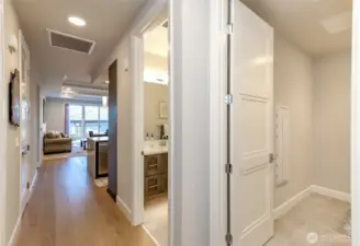 Entry with storage and pantry on the left and the laundry room and main bath to the right