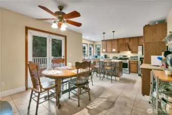 Convenient, spacious eating area just off the kitchen with direct access to the deck for indoor-outdoor living.