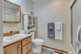 Main-level full guest bathroom, easily accessible for visitors and daily living.