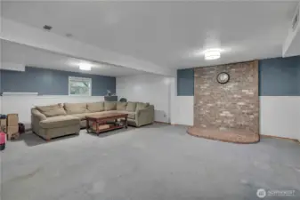 Spacious finished basement with a designated setup for a third woodstove.