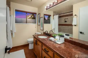 Second bathroom with jetted tub and granite counter.