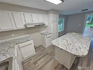 Well arranged kitchen with island prep space and eating bar