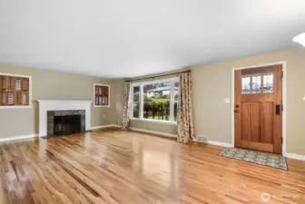 Beautiful Living Room w/hardwood floors, large picture windows & wood-burning slate fireplace