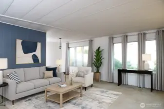 The living room seamlessly flows into the dining area, filled with natural light that creates a warm and inviting atmosphere. VIRTUALLY STAGED