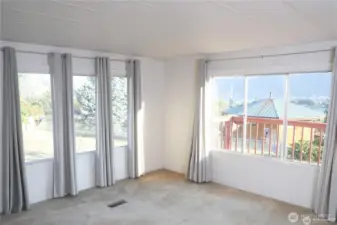 The dining room transitions smoothly into the spacious living area, enhancing the open-concept layout and natural light.