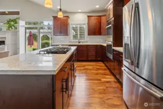The engineered hardwood floor continues through the Kitchen with soft-close drawers. Double wall oven. French door refrigerator with large drawer freezer.