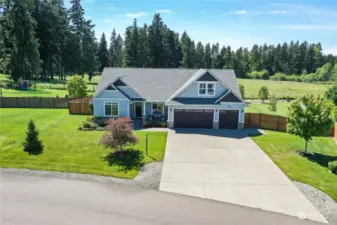 Long driveway with three car garage, room for all your toys and tools. Sitting on three quarters of an acre, the perfect size to sprawl out on.