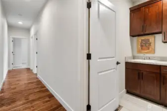 Laundry room is conveniently located near the two guest bedrooms as well as the garage. Crown molding tops the shaker style cabinetry. Granite counters with utility sink.