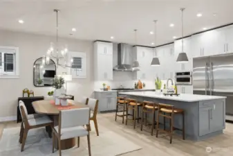 Another model showing similar color scheme. Finishes will vary. Enjoy hosting in your chef's kitchen equipped with JennAir appliances including 36” built-in refrigerator + 24” built in freezer, 48” dual fuel gas professional range with griddle, wall-mounted hood, built-in microwave oven with speed-cook.