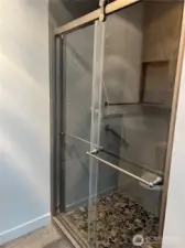 The 3/4 bath shower is beautifully updated and looks like a spa right off the primary bedroom