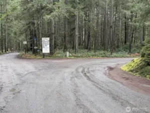 Huckleberry Road w/House Numbers. Follow Road As It Angles Right To Gate Access On Left.