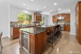 This kitchen has it all ... huge center island with eating space, dual dishwasher, and wine fridge.