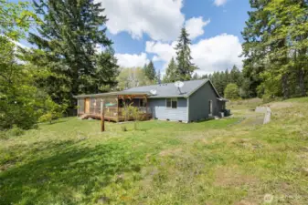 View of the back of the house with the massive 16x33, fully enclosed deck.