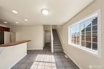 Living room looking back towards kitchen, entry and stairs to 2nd level.