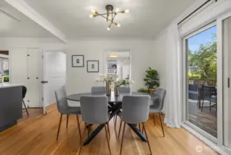 Sliders in dining room out to large deck and back yard
