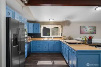 Kitchen with newer appliances and a window over the sink.