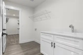 Quick access from primary to laundry room with sink