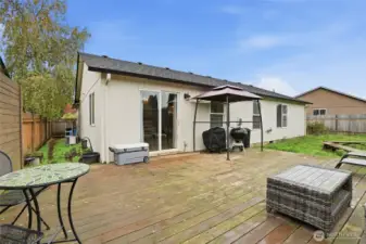 Fenced backyard with deck