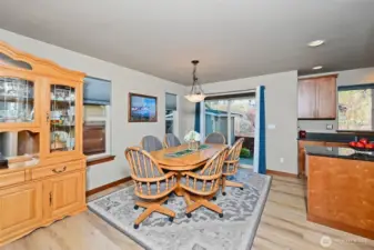 Dining room with LVP flooring and a slider to the back patio.
