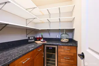 Butler's pantry with a wine fridge and lots of storage and counter space.