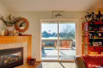 Living room with slider leads to private back deck with warm daytime views to the south. Enjoy cozy nights by the fireplace