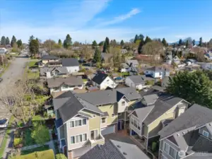 Aerial view of residential neighborhood showing multi-story homes, surrounding streets, and nearby houses.