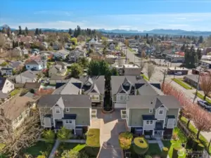Aerial view of townhome community with central courtyard, fountain, and surrounding residential area.