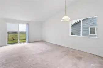 Ample sized living room with dining area and fireplace.