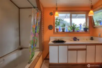 Deep soaker tub in Primary bathroom with double vanity sinks.