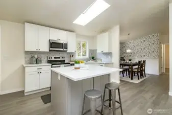 This is a fully new kitchen with breakfast bar, new cabinets, & new appliances.