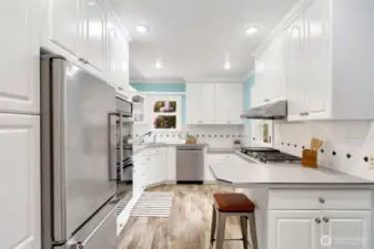Uplifiting, efficient and inspiring kitchen that leads to back deck.