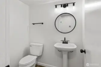 Updated powder room on the main level, with a spacious storage closet nearby (not pictured).