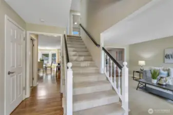 Step inside to a bright and functional layout. A welcoming staircase draws your eyes upward to the second floor, while warm hardwood flooring leads you straight ahead into the heart of the home.