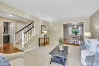This spacious living area flows naturally into the formal dining room, making it ideal for entertaining. A thoughtfully placed powder bath is conveniently located near the entry.